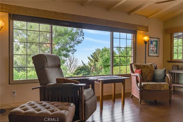 a living room with furniture a fireplace and a large window