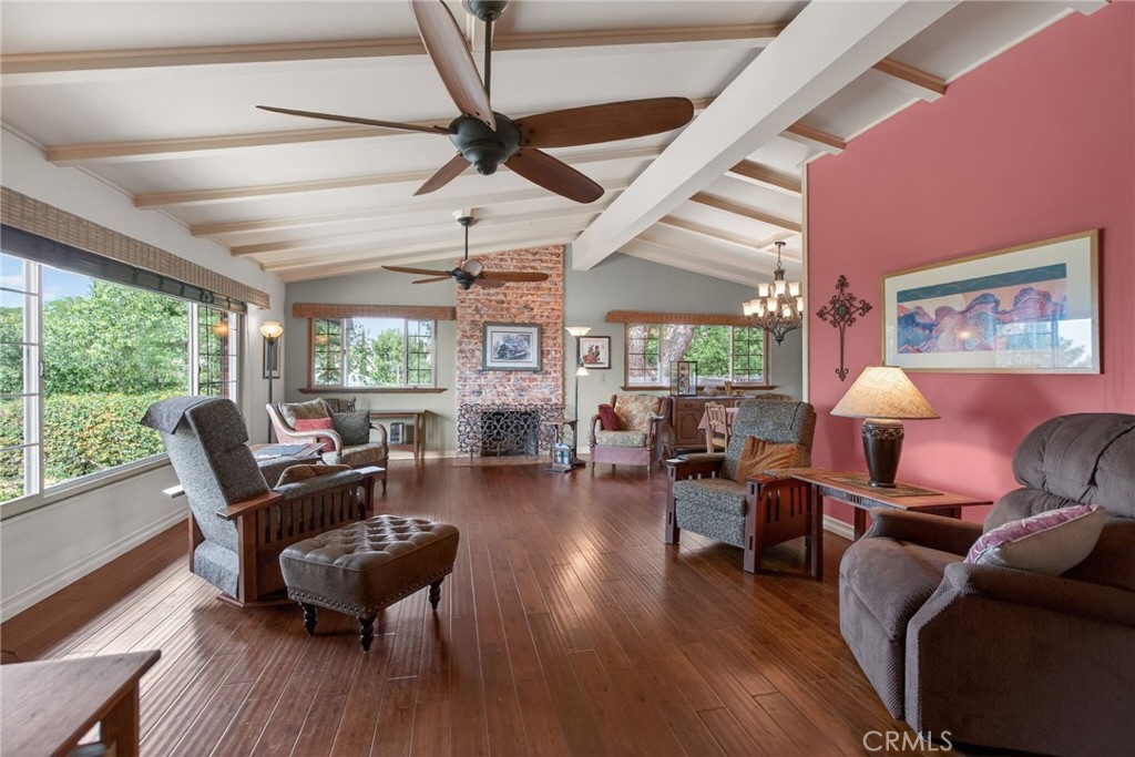 11543 Tulane Avenue Riverside, CA 92507 - Photo 14 of 49 Open beam ceilings and engineered wood flooring create a bright and airy atmosphere in the room.