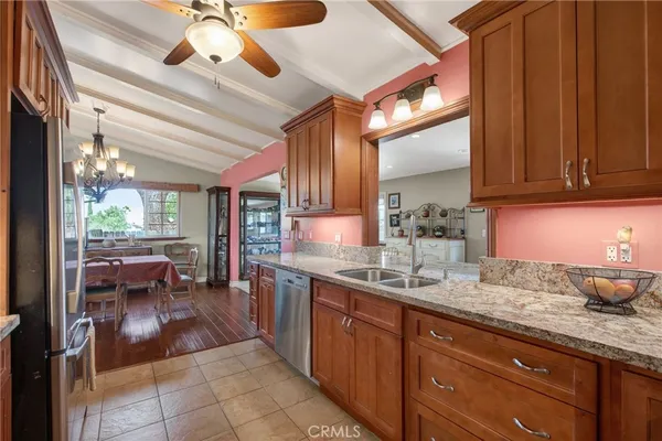 a kitchen with stainless steel appliances granite countertop a stove microwave and sink