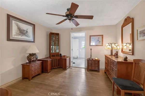 a view of a hallway to a livingroom with furniture and windows