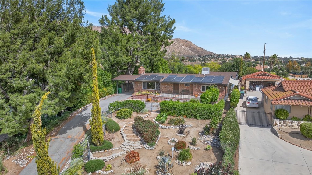 11543 Tulane Avenue Riverside, CA 92507 - Photo 3 of 49 The front garden is landscaped with a desert walking garden. The home has leased solar panels which offset utility costs.