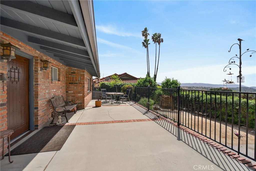 11543 Tulane Avenue Riverside, CA 92507 - Photo 6 of 49 The front porch runs the entire length of the home. Notice the brick accents and custom solid wood front door.