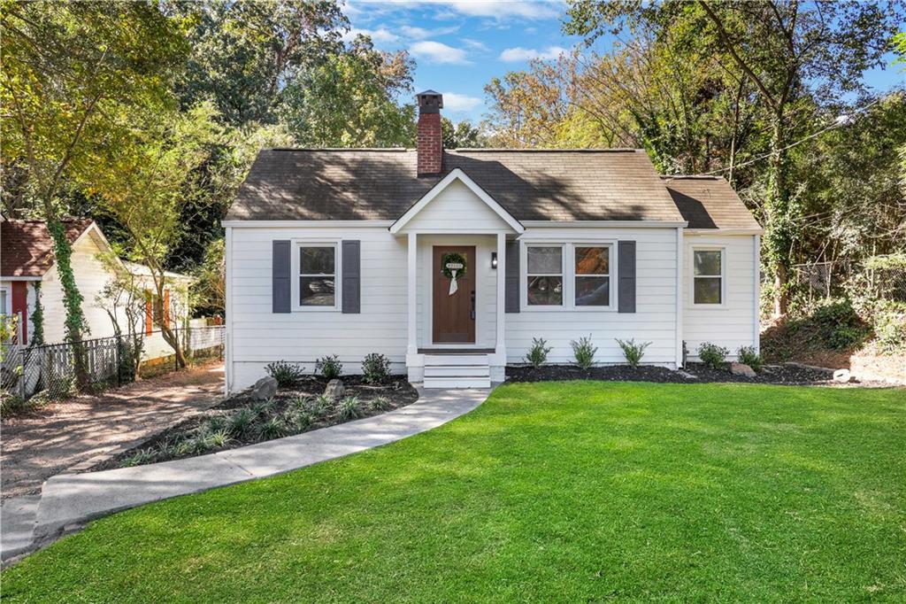 a front view of a house with a garden