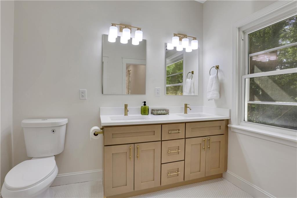 207 Walthall Street Marietta, GA 30064 - Photo 28 of 42 a bathroom with a toilet a sink a large mirror and vanity