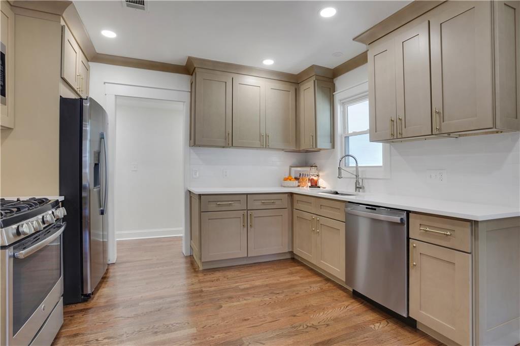 207 Walthall Street Marietta, GA 30064 - Photo 3 of 42 a kitchen with granite countertop white cabinets and white appliances
