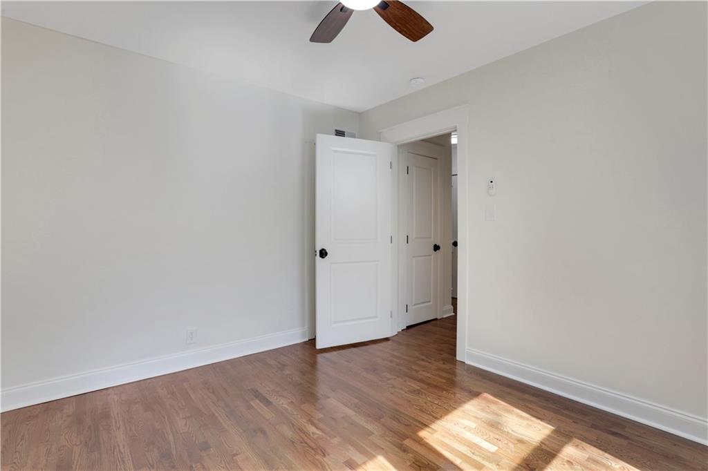207 Walthall Street Marietta, GA 30064 - Photo 33 of 42 an empty room with wooden floor cabinet and windows