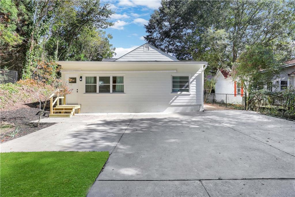 207 Walthall Street Marietta, GA 30064 - Photo 40 of 42 a front view of a house with a yard and garage