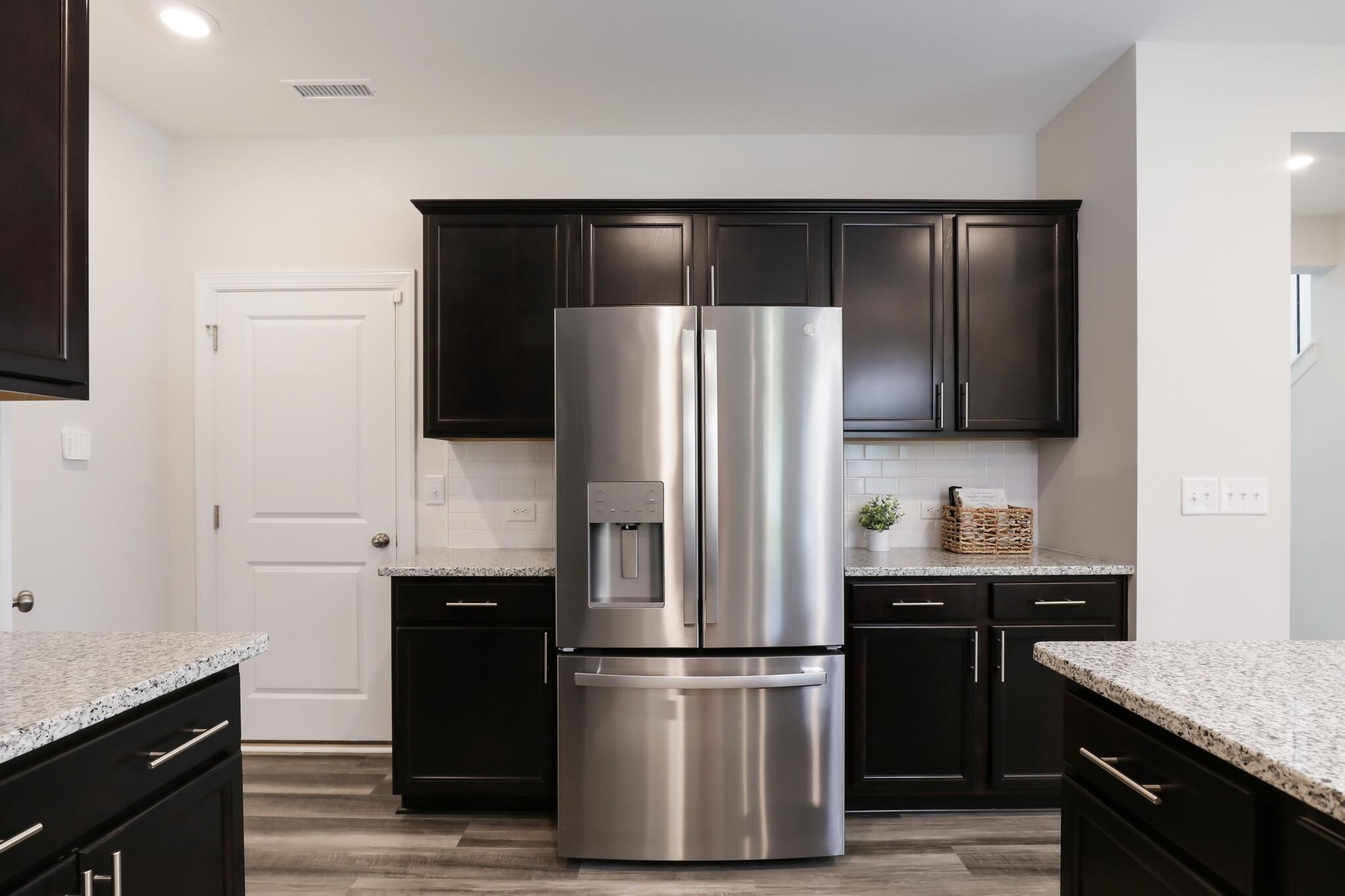 709 Spoonbill Trail Durham, NC 27703 - Photo 12 of 39 a kitchen with stainless steel appliances a refrigerator a sink and wooden cabinets