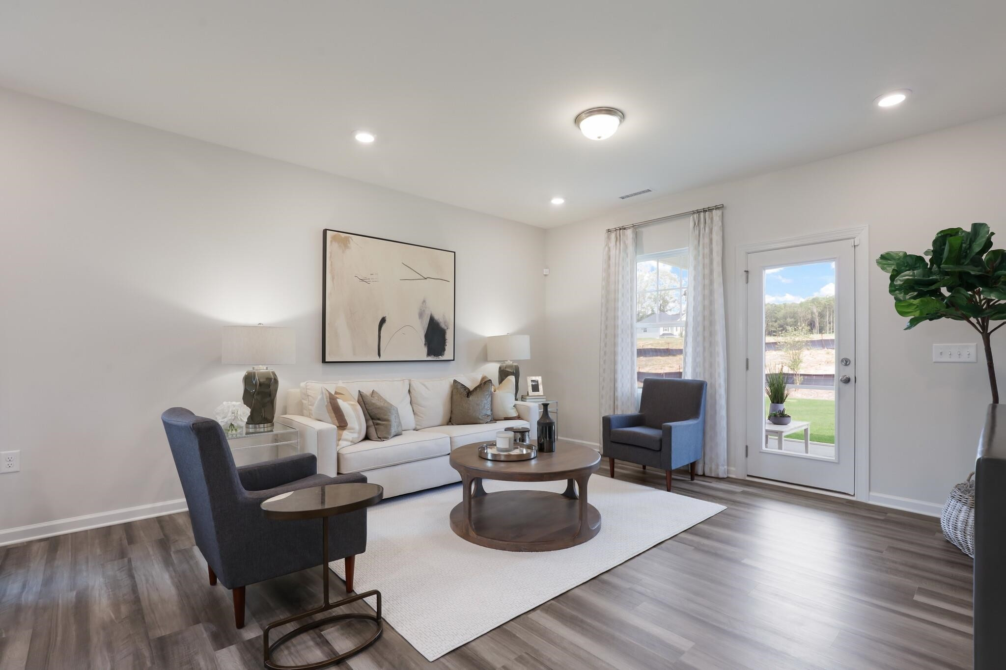 709 Spoonbill Trail Durham, NC 27703 - Photo 16 of 39 a living room with furniture and a wooden floor