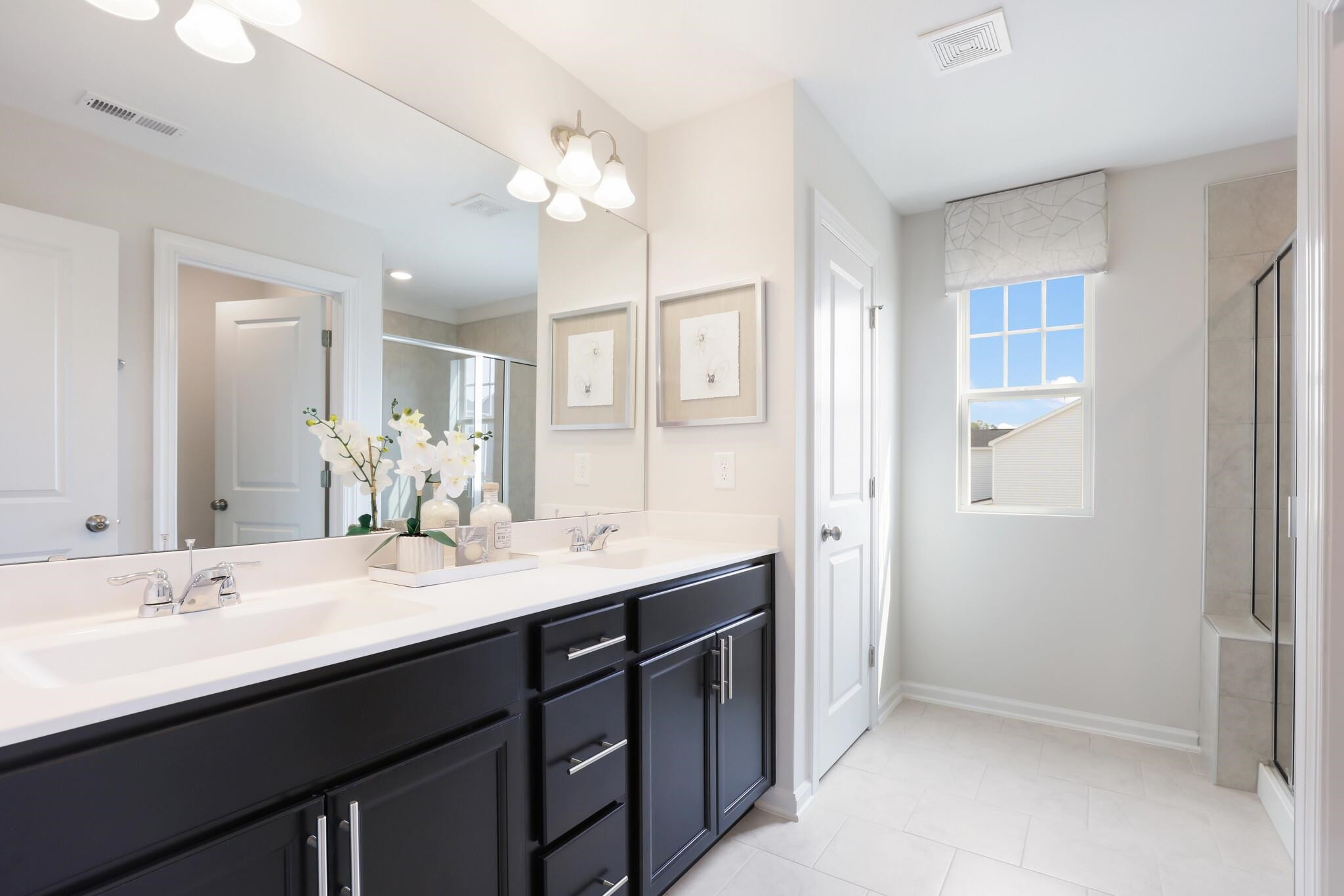 709 Spoonbill Trail Durham, NC 27703 - Photo 22 of 39 a bathroom with a sink double vanity granite and a mirror