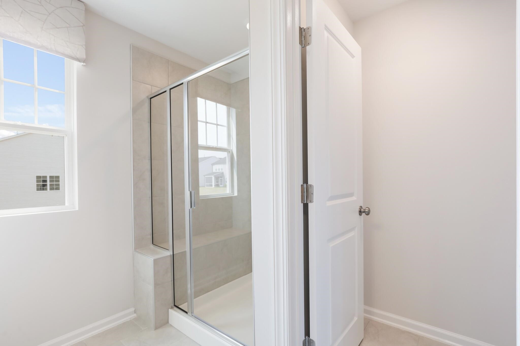 709 Spoonbill Trail Durham, NC 27703 - Photo 23 of 39 a bathroom with a glass shower door
