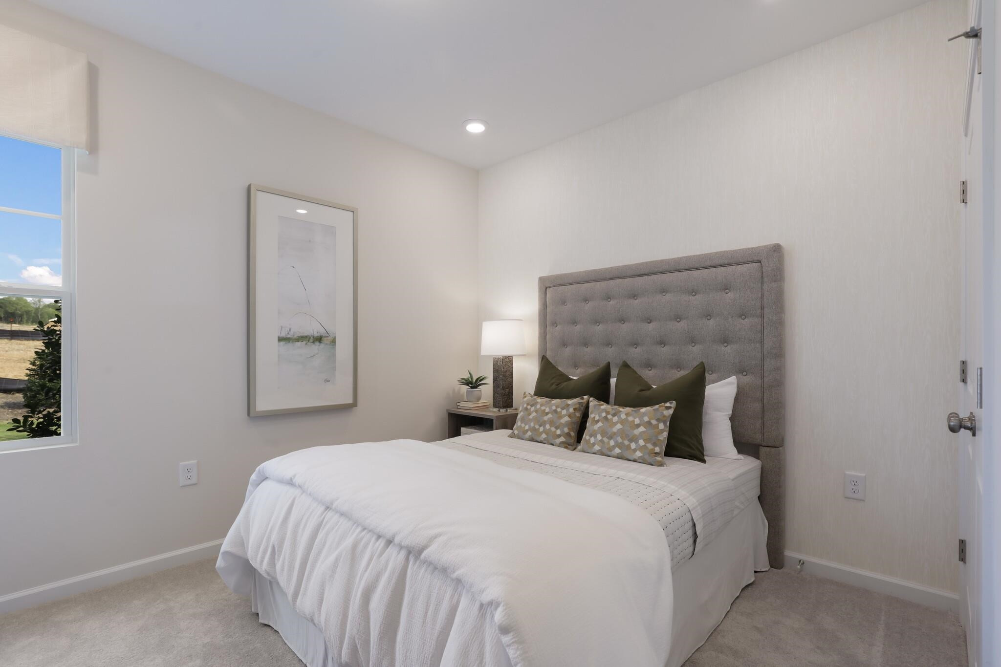 709 Spoonbill Trail Durham, NC 27703 - Photo 25 of 39 a bedroom with a bed and a night stand