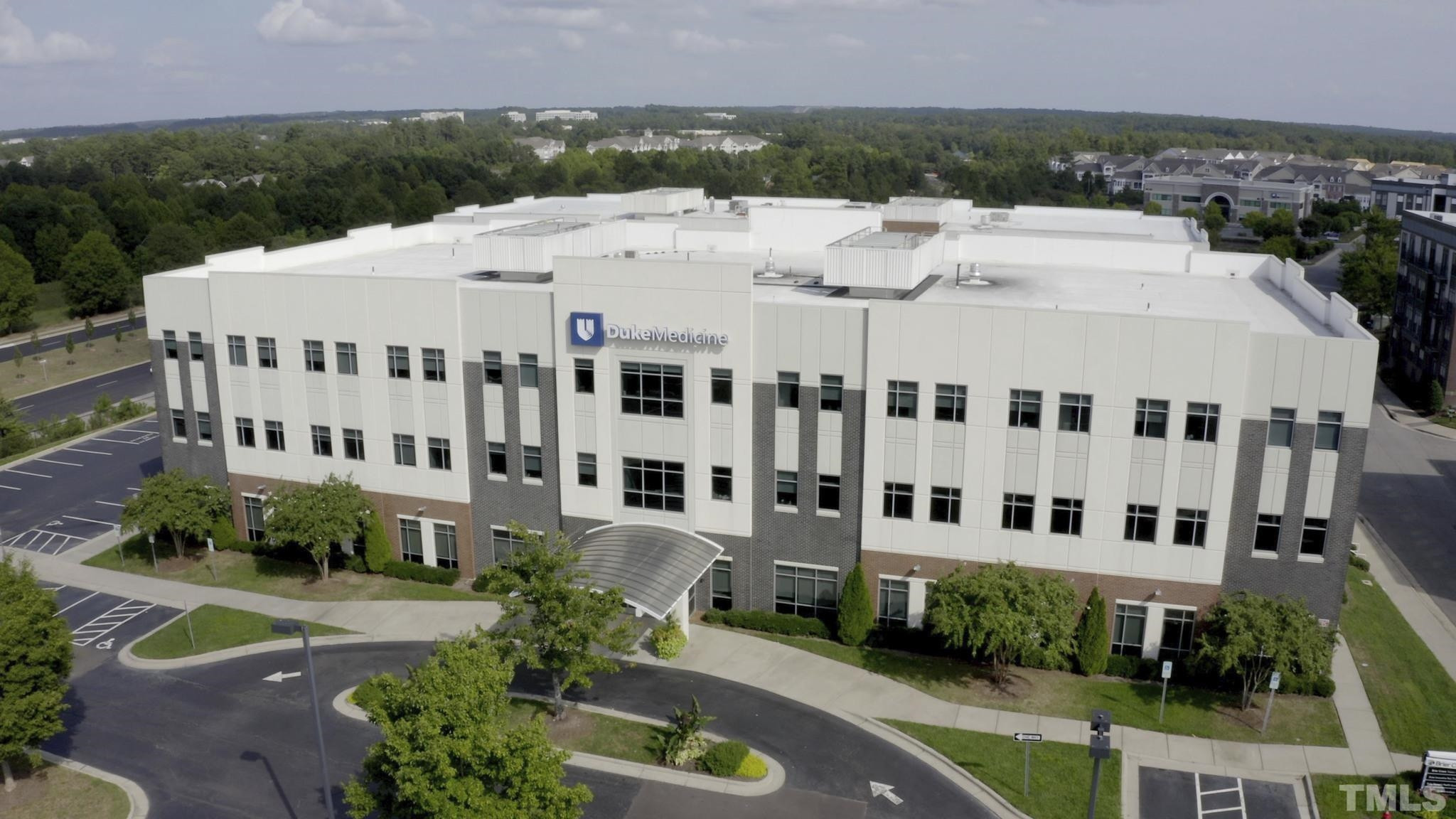709 Spoonbill Trail Durham, NC 27703 - Photo 37 of 39 a large building with a small yard