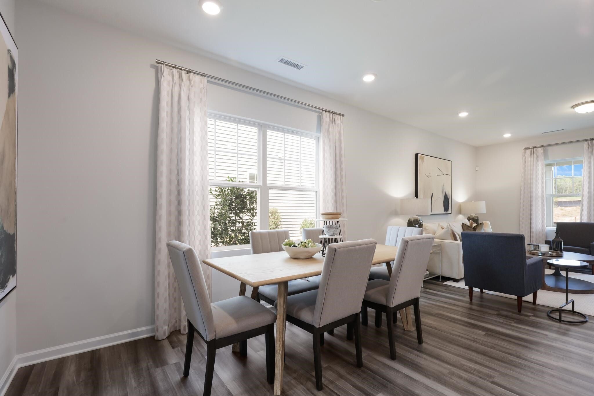 709 Spoonbill Trail Durham, NC 27703 - Photo 6 of 39 a view of a dining room with furniture and wooden floor