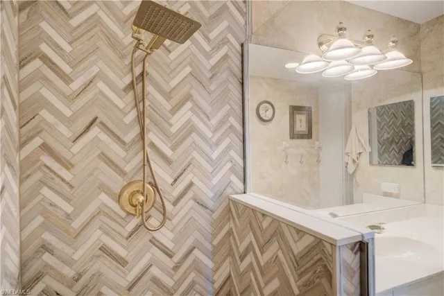 a bathroom with a sink a toilet a mirror and shower