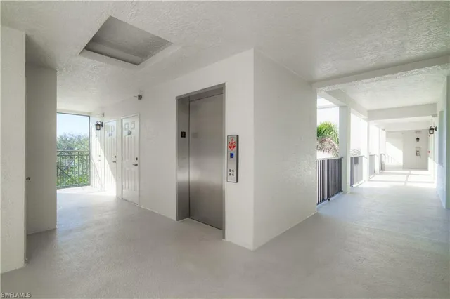 a view of a hallway with wooden shelves