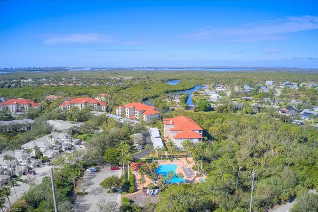 an aerial view of a house with a garden and lake view