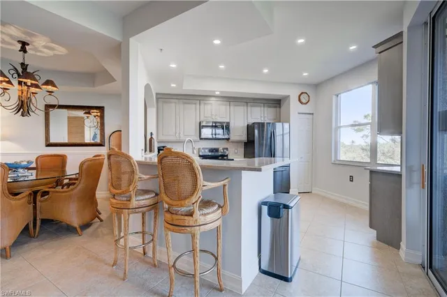 a kitchen with stainless steel appliances granite countertop white cabinets and stove