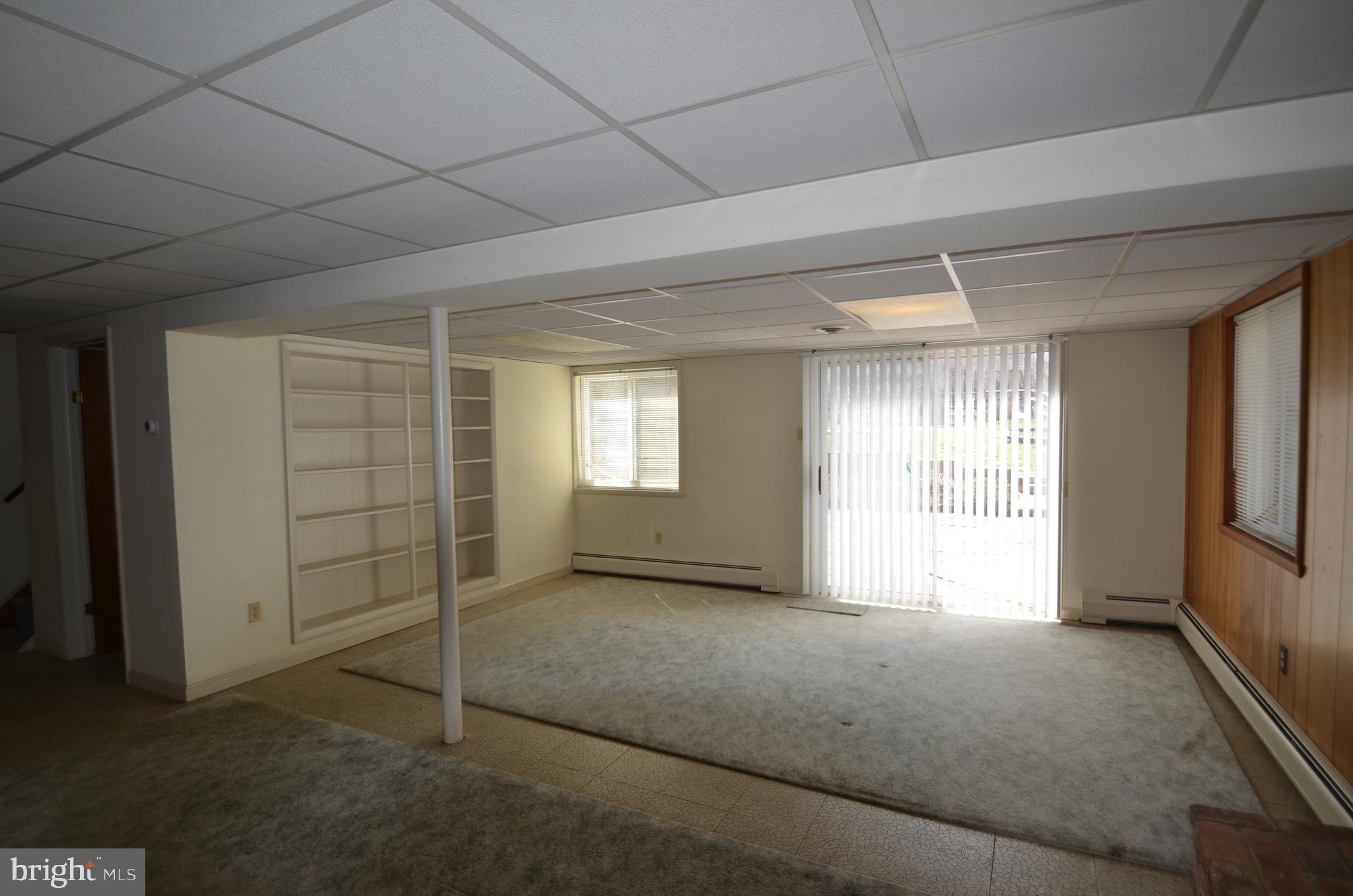 15930 Woods Center Road Silver Spring, MD 20906 - Photo 17 of 33 Rec room with builtins and slider to second patio
