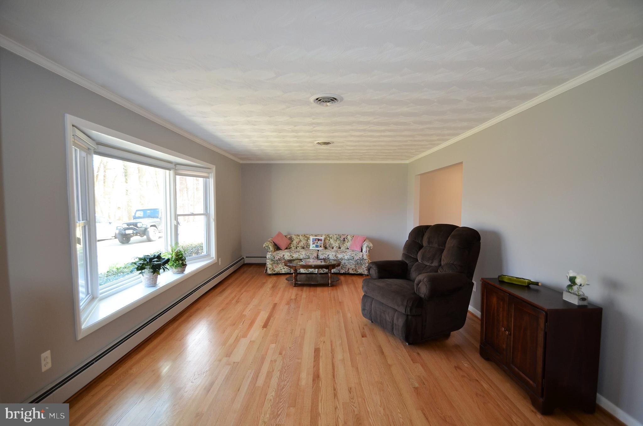 15930 Woods Center Road Silver Spring, MD 20906 - Photo 6 of 33 Bright open living room w/hardwood floors