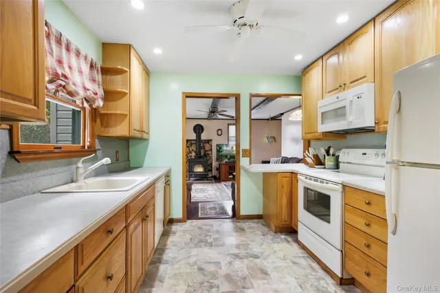 a kitchen with a sink stove and cabinets