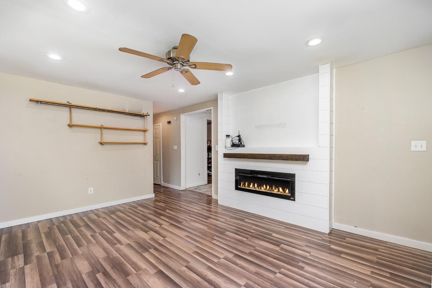704-3 Juniper Road Valparaiso, IN 46385 - Photo 5 of 24 a view of an empty room with wooden floor fireplace and a window