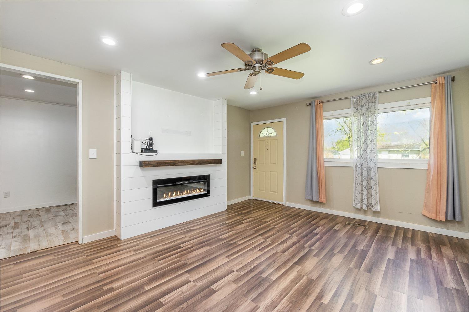 704-3 Juniper Road Valparaiso, IN 46385 - Photo 6 of 24 an empty room with windows a fireplace and wooden floor