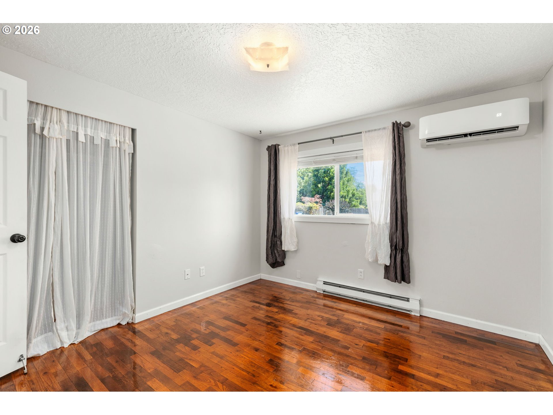 10245 Southeast Raymond Street Portland, OR 97266 - Photo 11 of 25 a view of an empty room with wooden floor