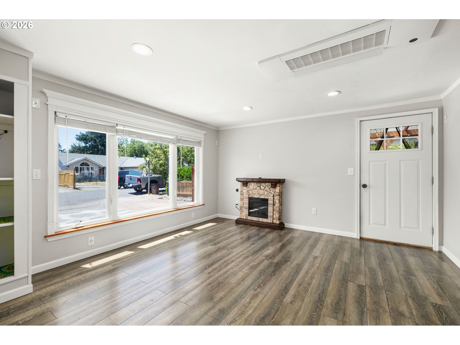 10245 Southeast Raymond Street Portland, OR 97266 - Photo 13 of 25 a view of an empty room with wooden floor and a window