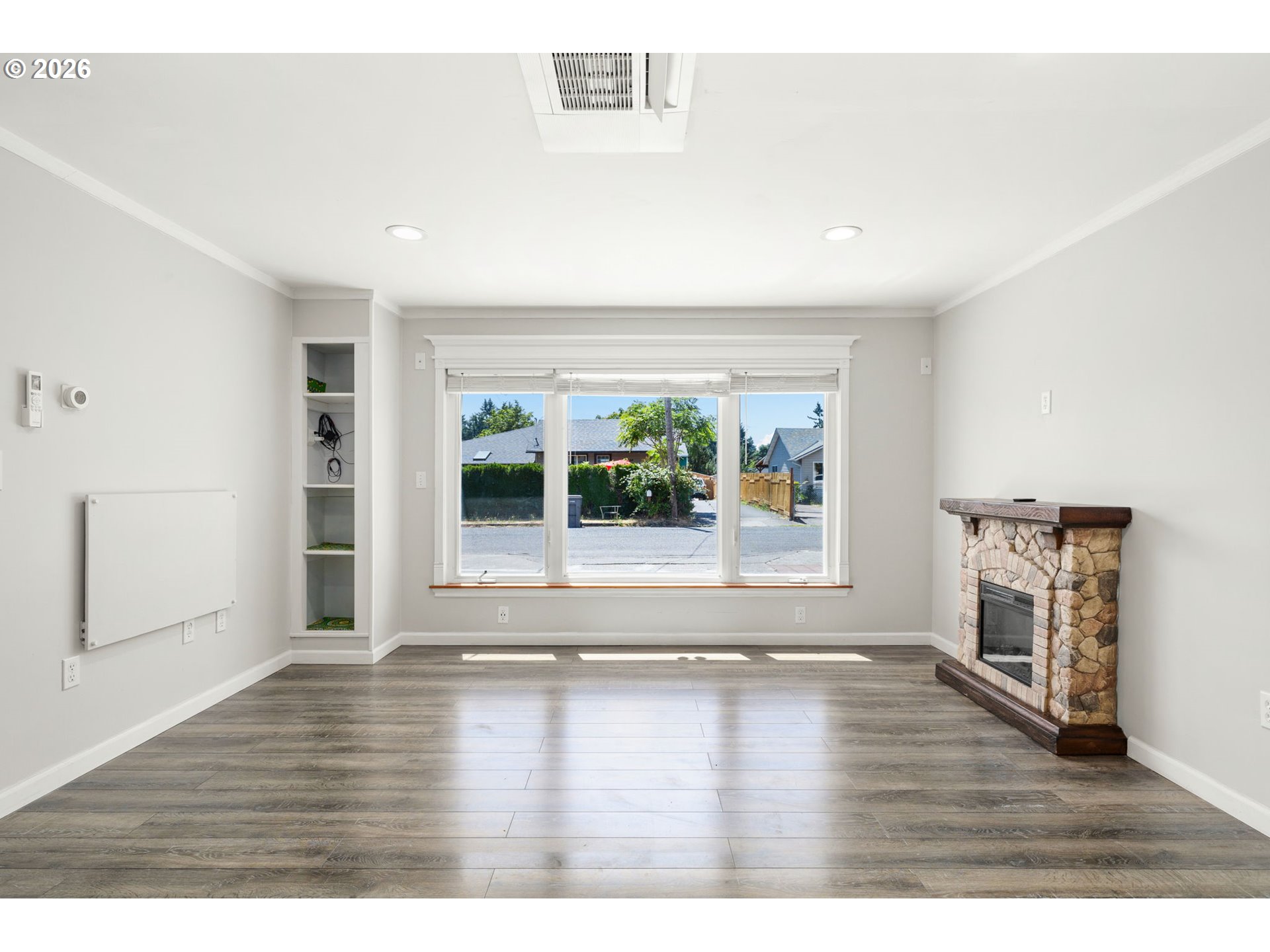 10245 Southeast Raymond Street Portland, OR 97266 - Photo 14 of 25 an empty room with wooden floor and windows