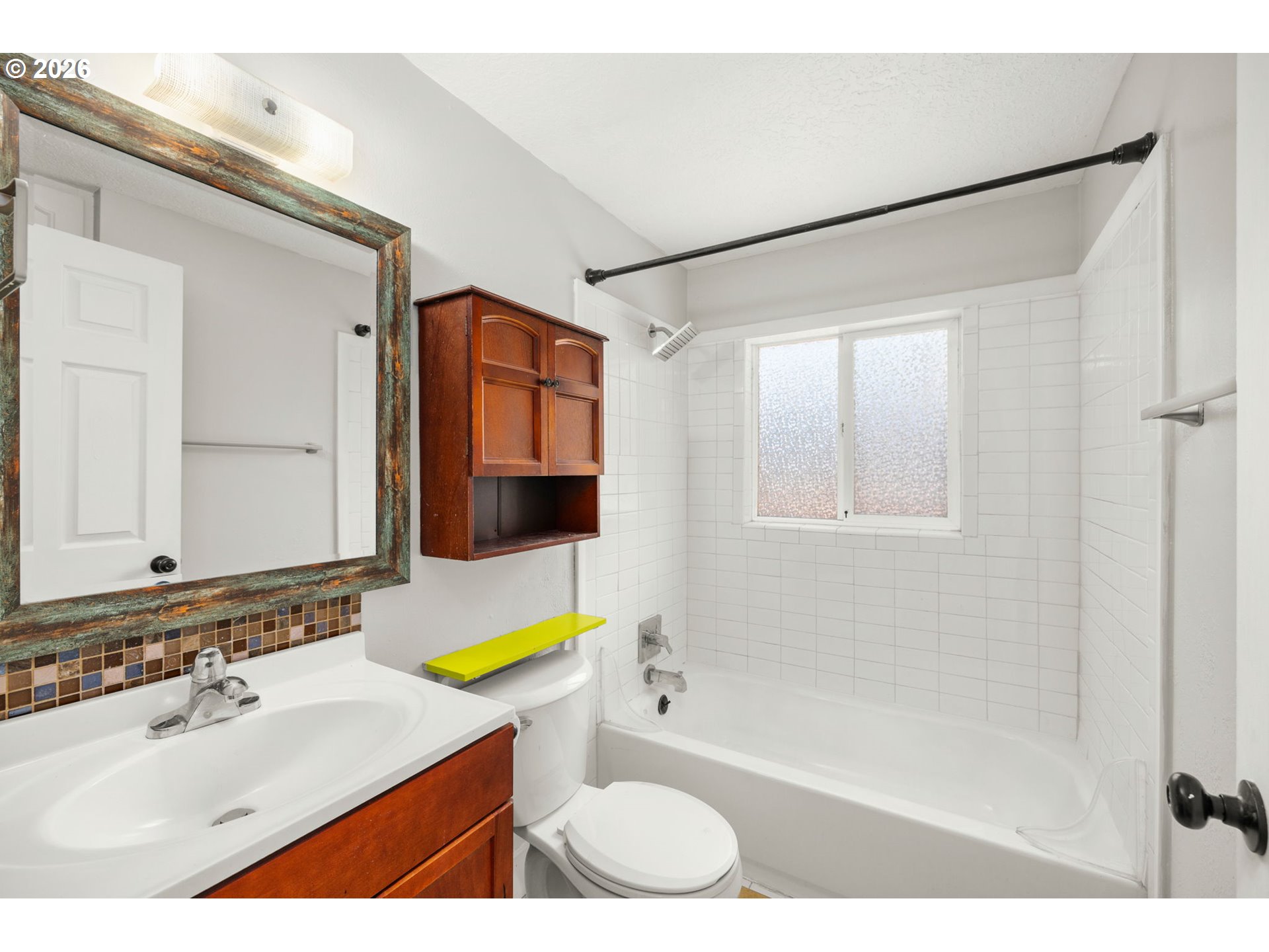 10245 Southeast Raymond Street Portland, OR 97266 - Photo 15 of 25 a bathroom with a sink mirror toilet and bathtub