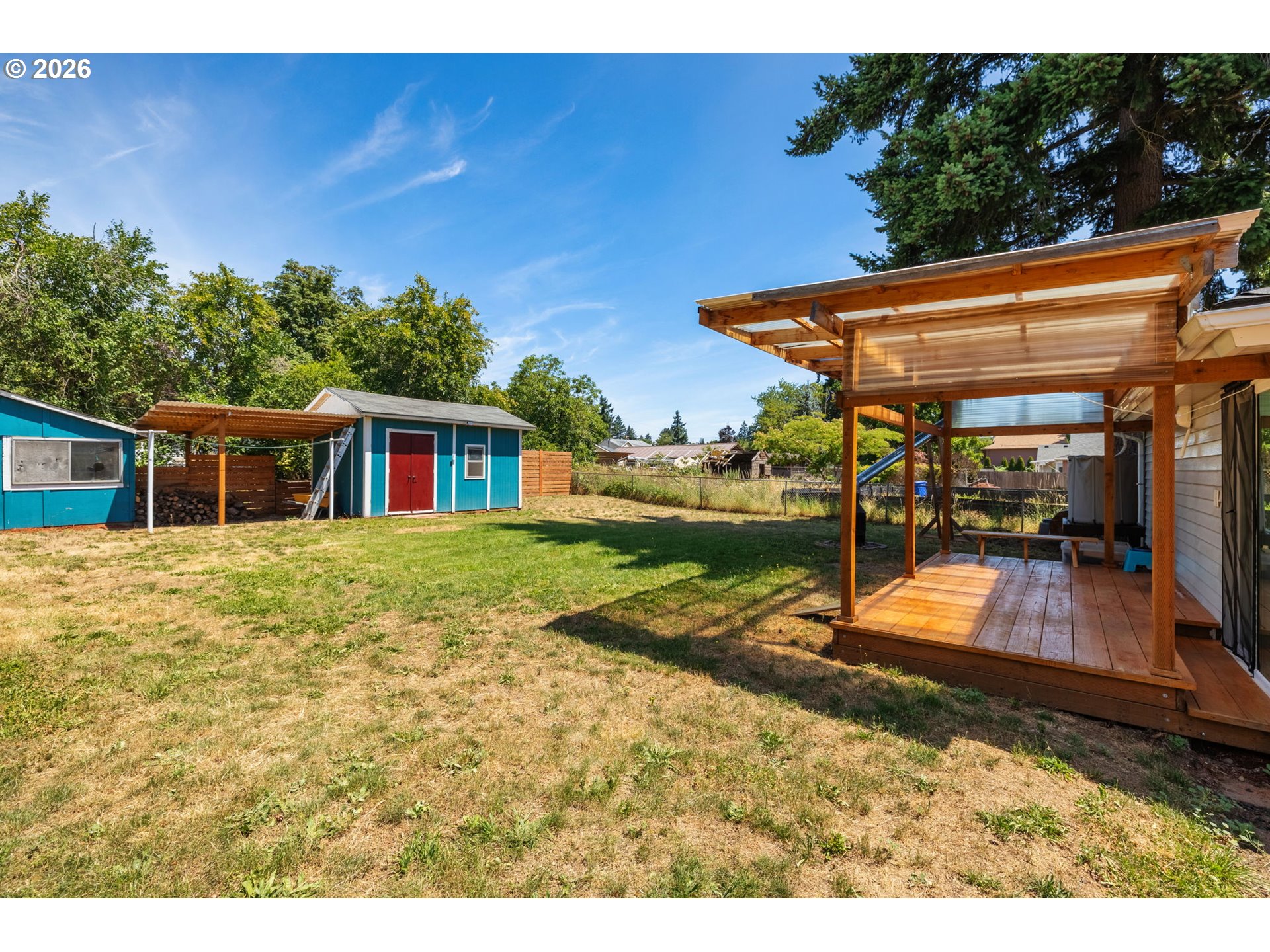 10245 Southeast Raymond Street Portland, OR 97266 - Photo 19 of 25 a view of a backyard with a tub and wooden fence