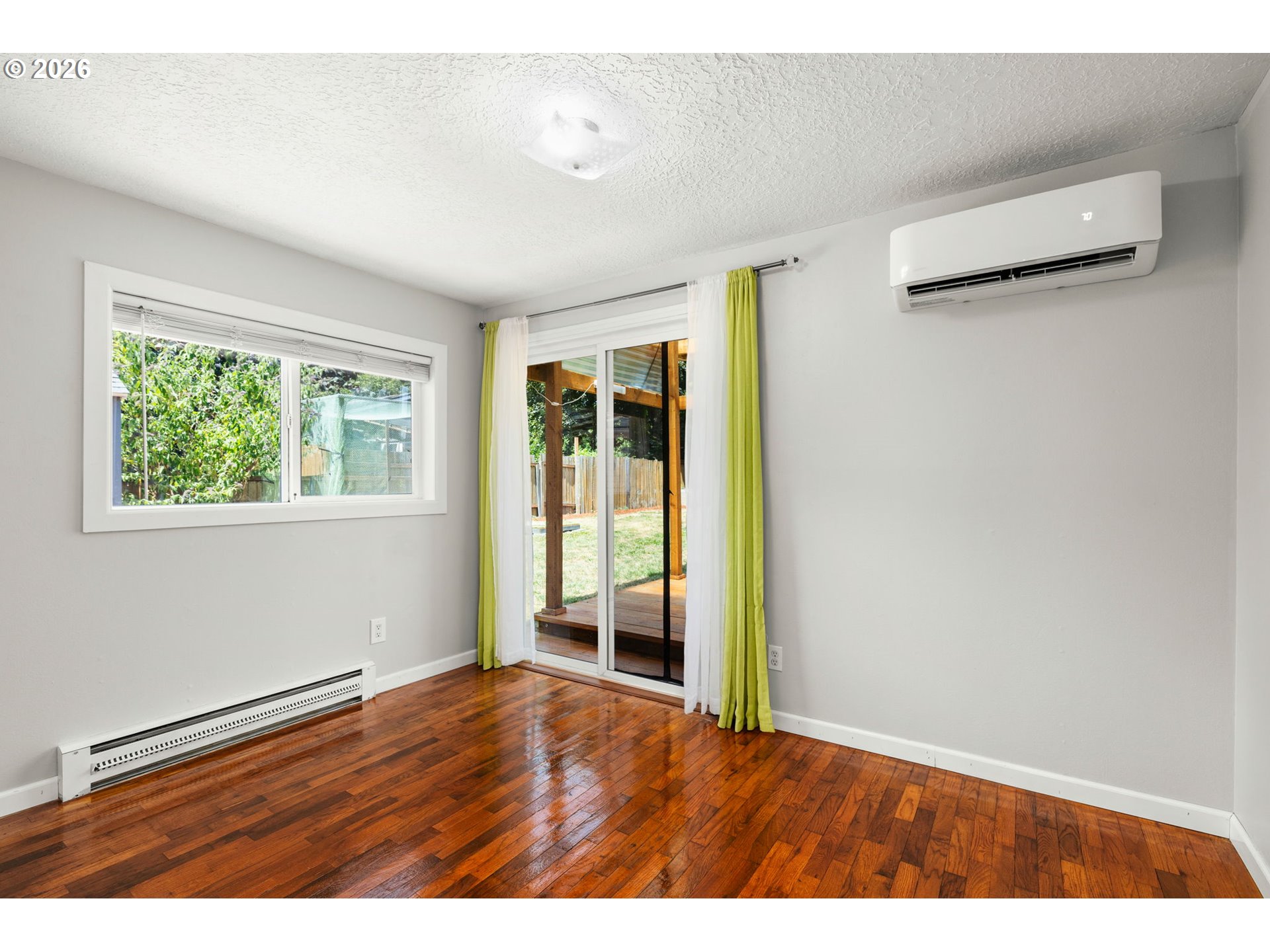 10245 Southeast Raymond Street Portland, OR 97266 - Photo 9 of 25 a view of an empty room with wooden floor and a window