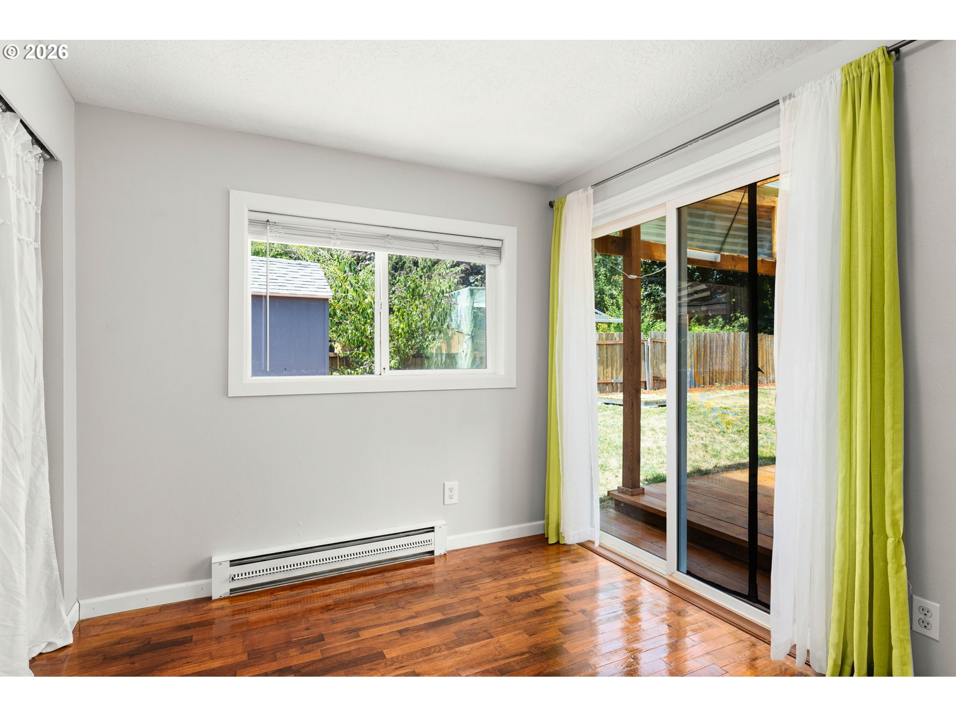 10245 Southeast Raymond Street Portland, OR 97266 - Photo 10 of 25 a view of an empty room with wooden floor and a window