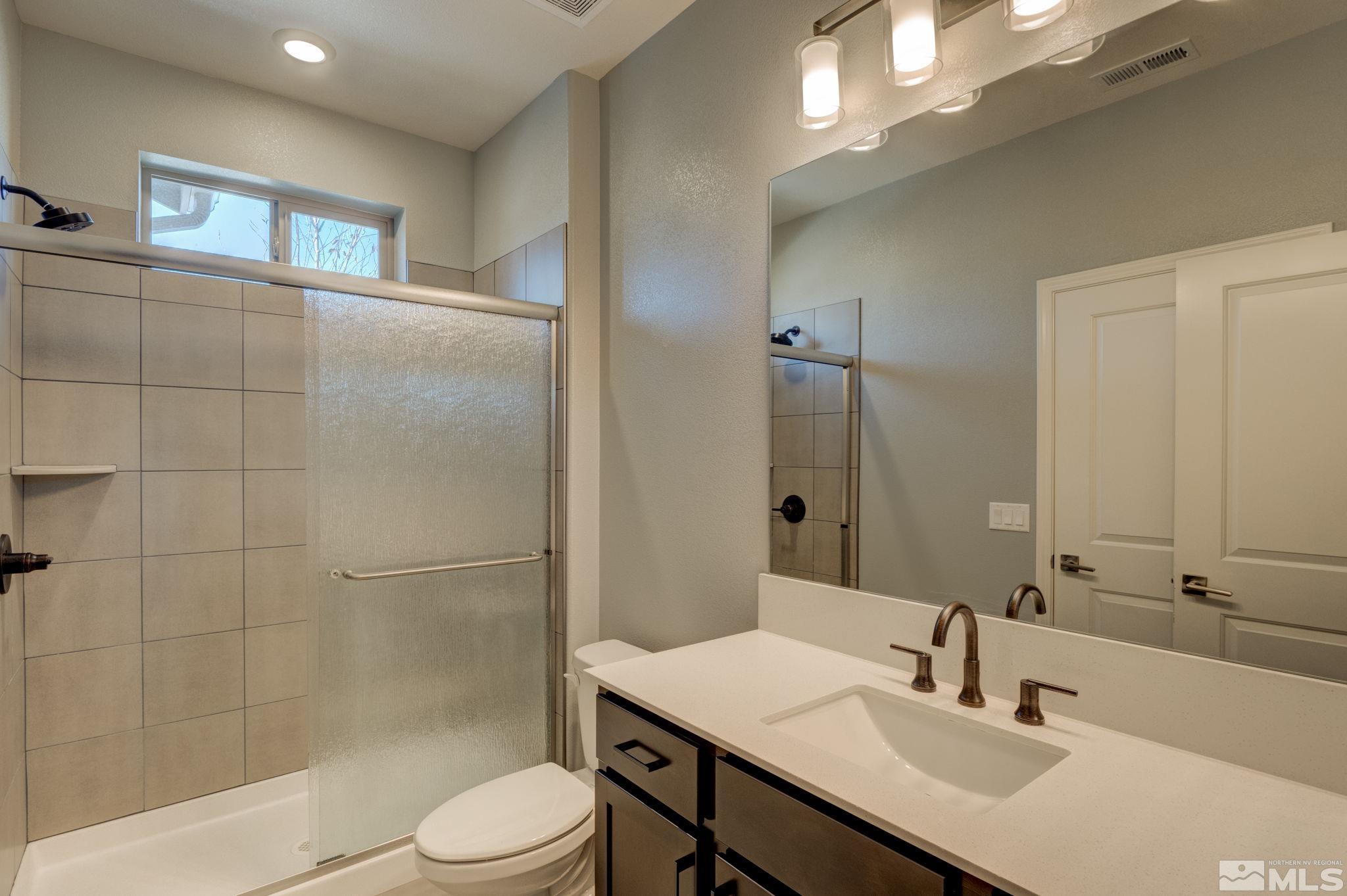 607 Riverbed Circle Reno, NV 89521 - Photo 19 of 40 a bathroom with a sink toilet and shower