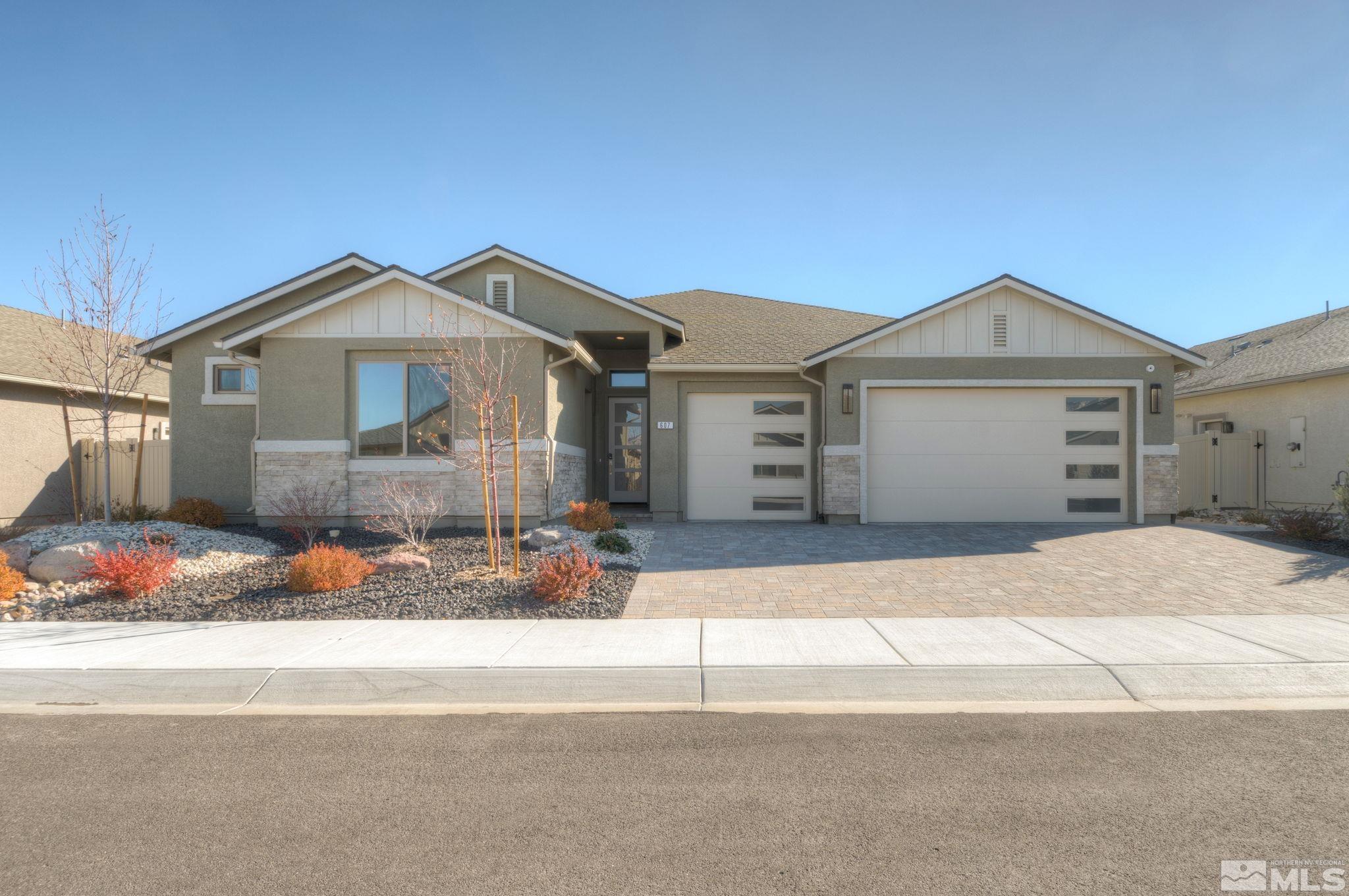 607 Riverbed Circle Reno, NV 89521 - Photo 2 of 40 a front view of a house with a garage