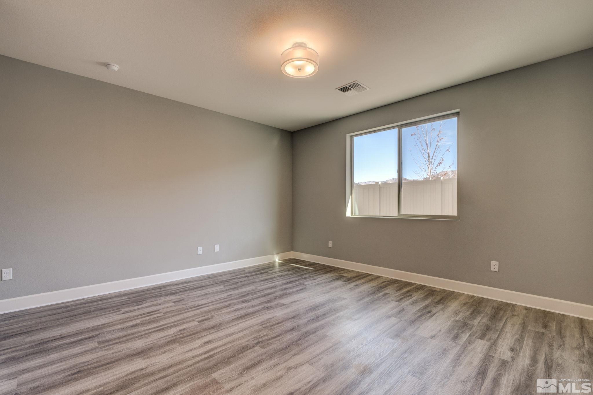 607 Riverbed Circle Reno, NV 89521 - Photo 23 of 40 a view of empty room with wooden floor and fan
