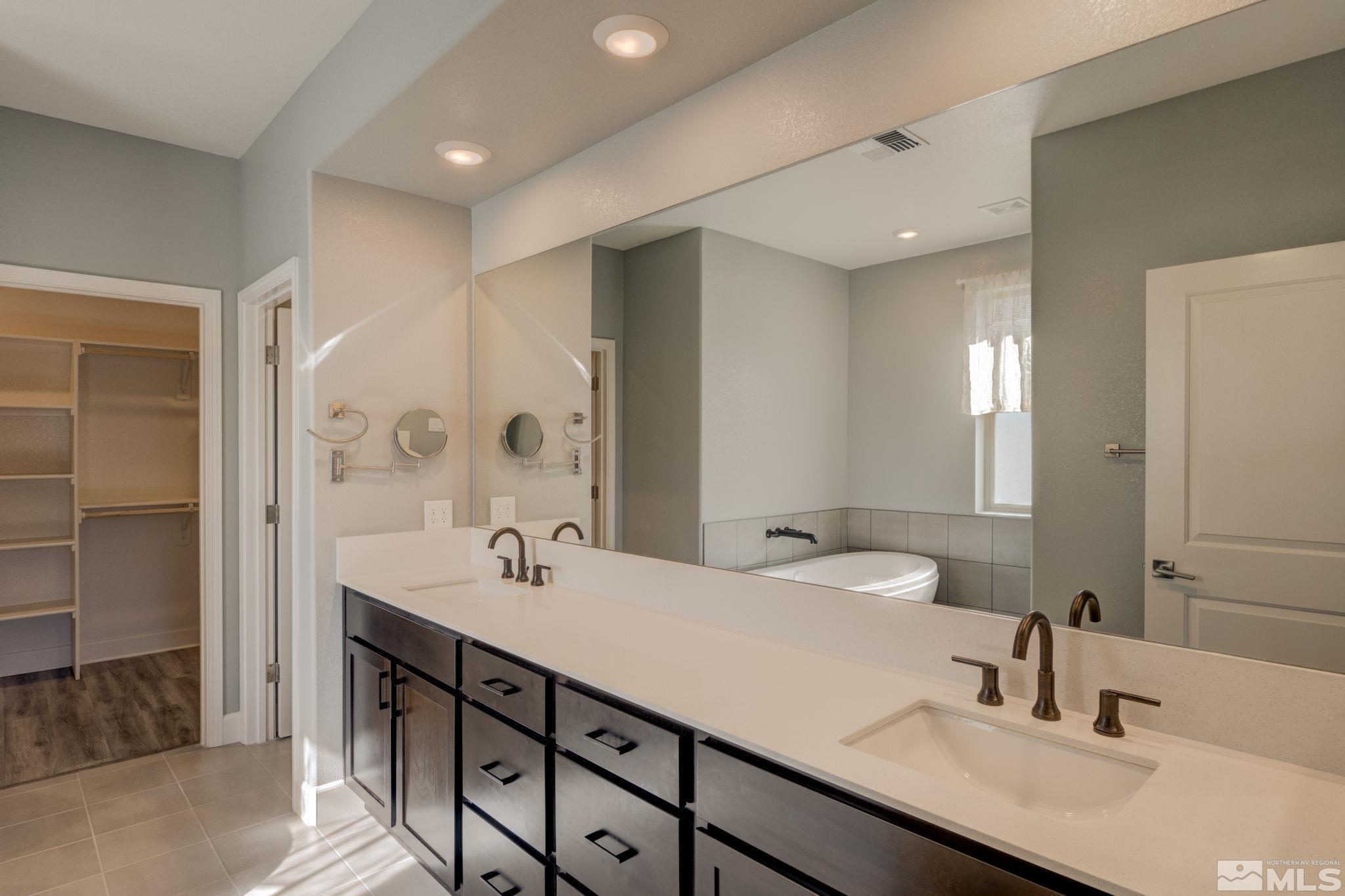 607 Riverbed Circle Reno, NV 89521 - Photo 25 of 40 a bathroom with a sink double vanity and a mirror