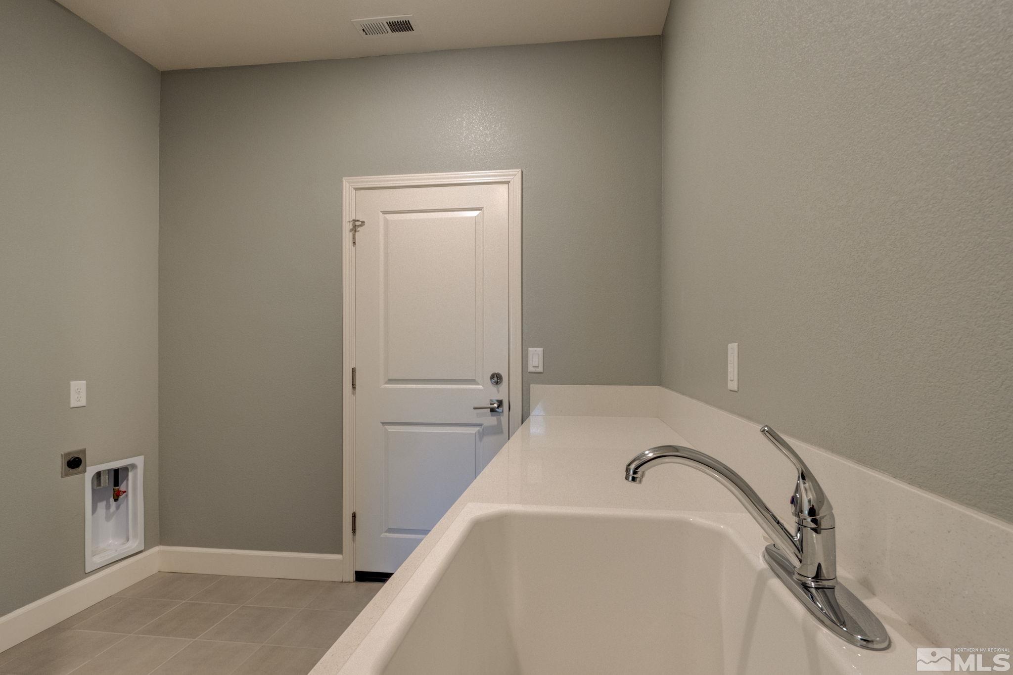 607 Riverbed Circle Reno, NV 89521 - Photo 29 of 40 a bathroom with a tub and shower