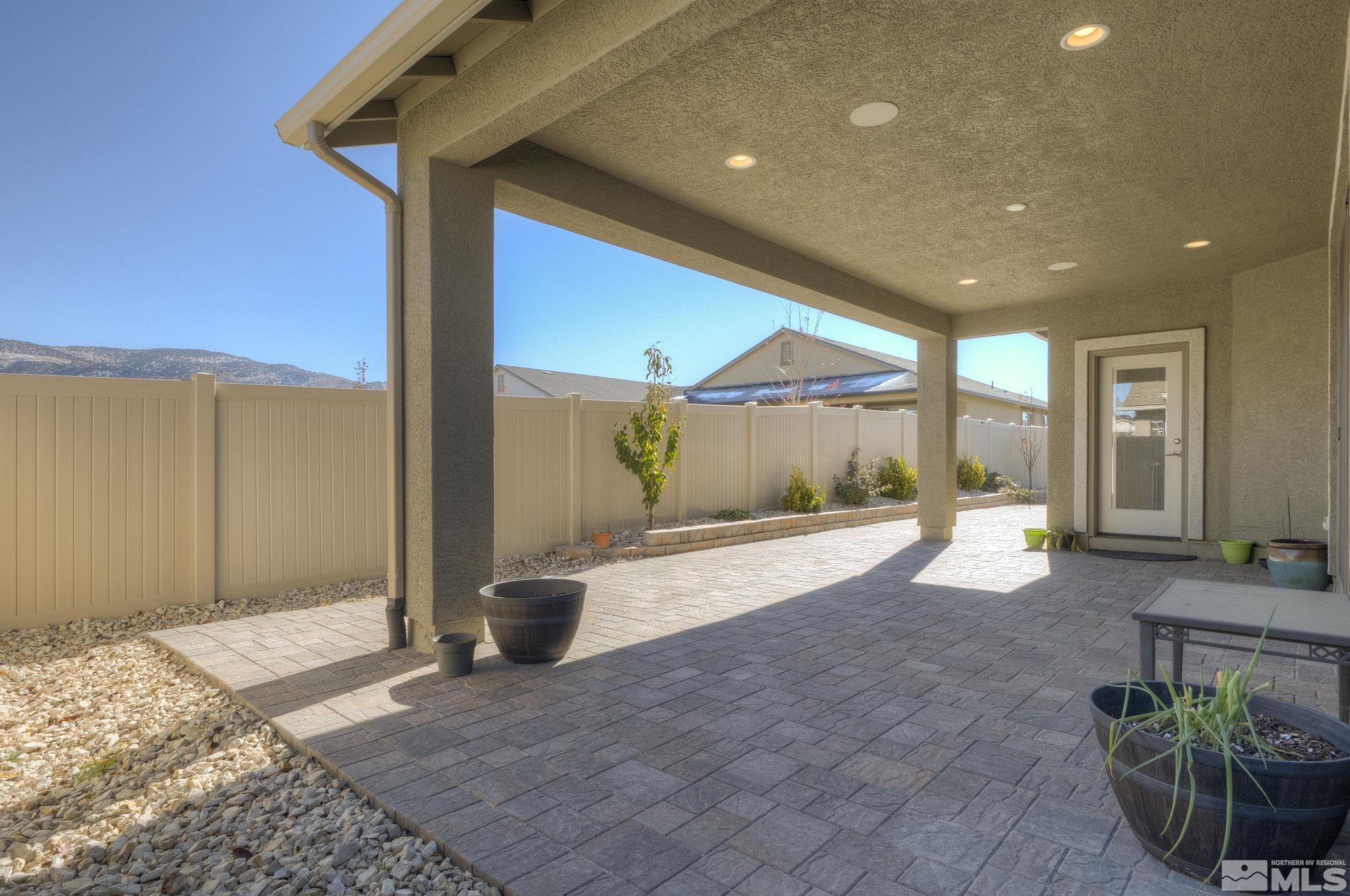 607 Riverbed Circle Reno, NV 89521 - Photo 32 of 40 a view of a porch with a table and chairs and potted plants