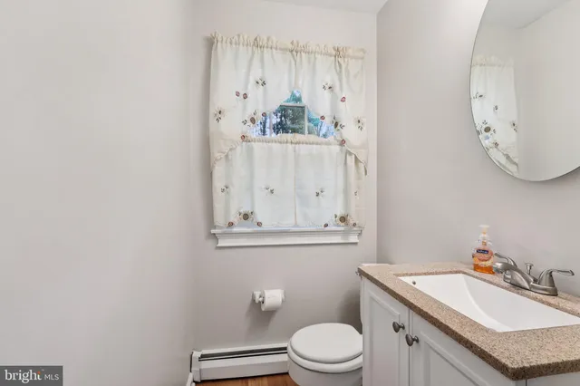 a bathroom with a granite countertop sink a mirror and a shower