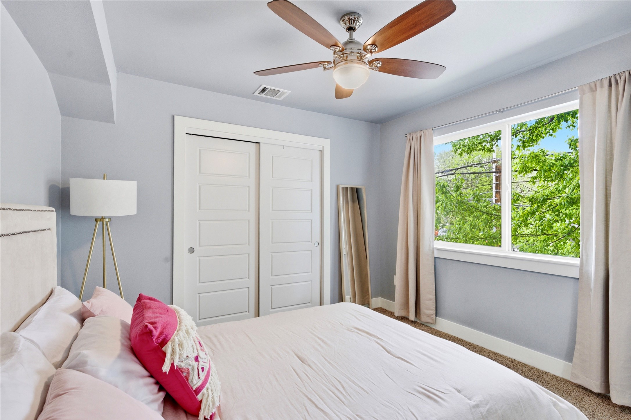 2202 Willow Street, Unit B Austin, TX 78702 - Photo 15 of 21 Carpeted bedroom featuring a closet and a ceiling fan