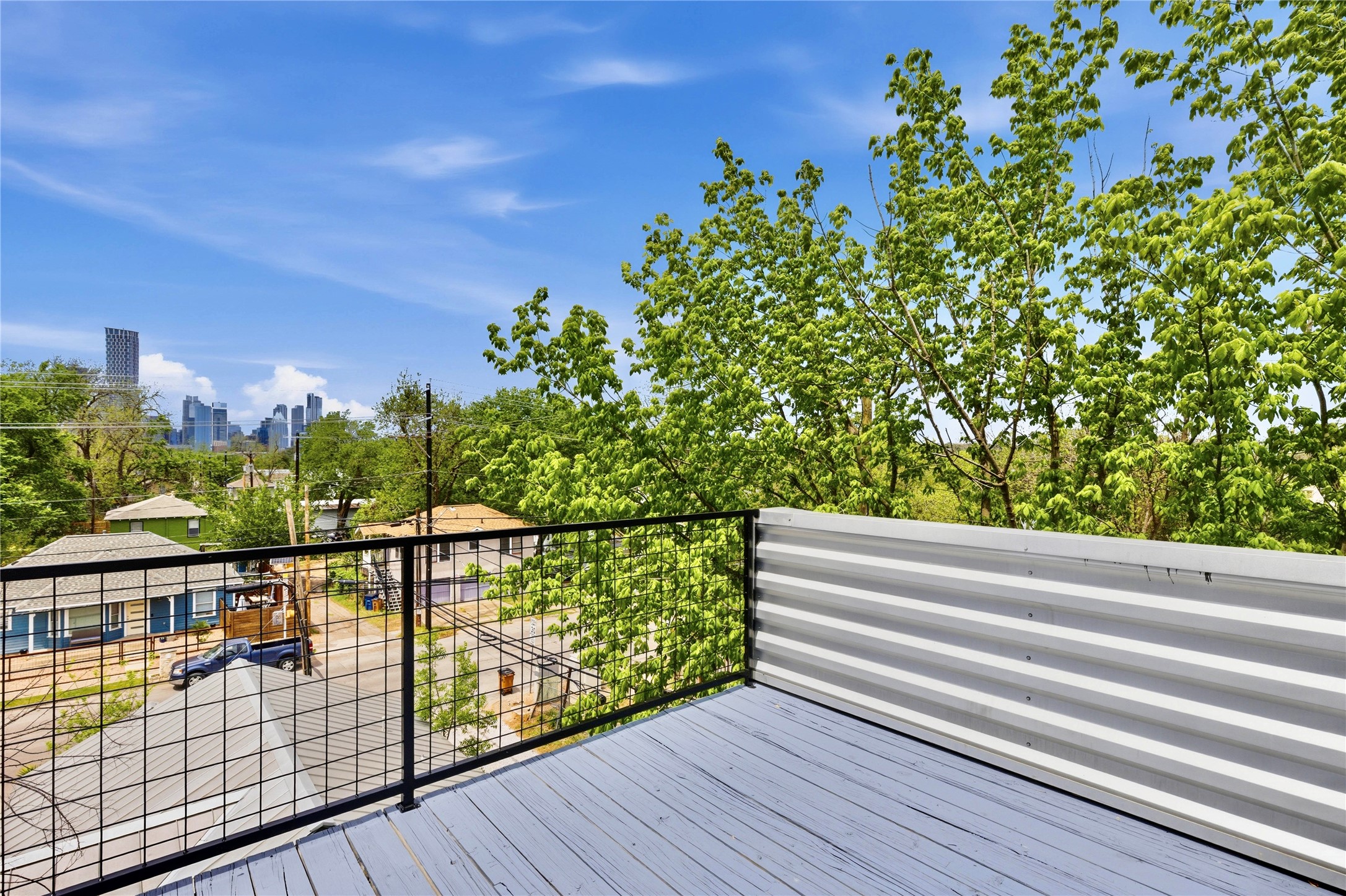 2202 Willow Street, Unit B Austin, TX 78702 - Photo 20 of 21 Deck featuring a skyline view and view of wooded area