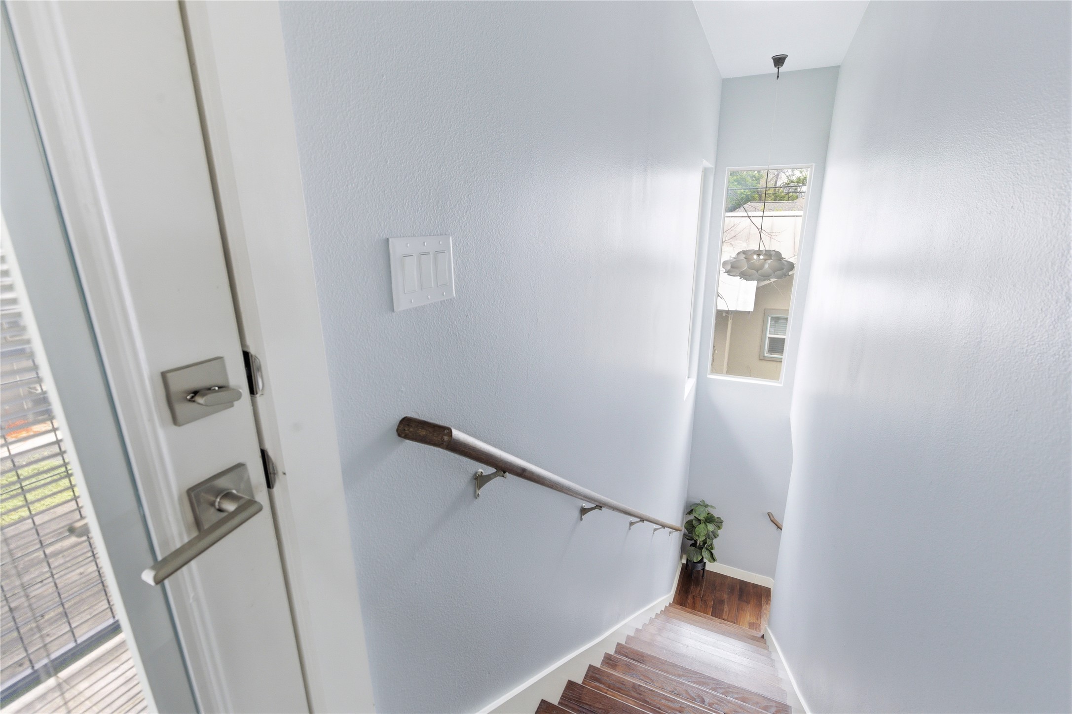 2202 Willow Street, Unit B Austin, TX 78702 - Photo 9 of 21 Staircase with baseboards and wood finished floors