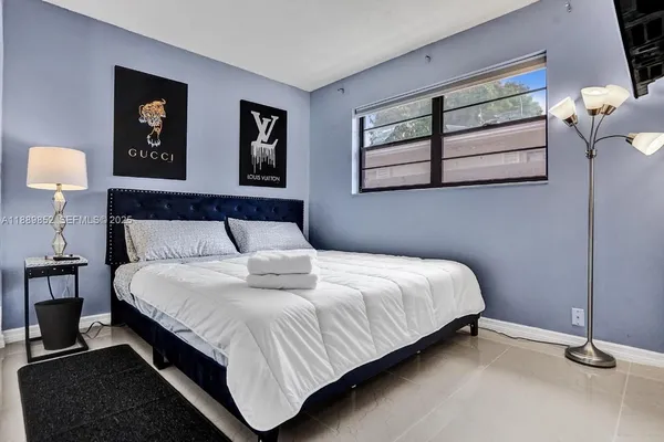a bedroom with a bed and window