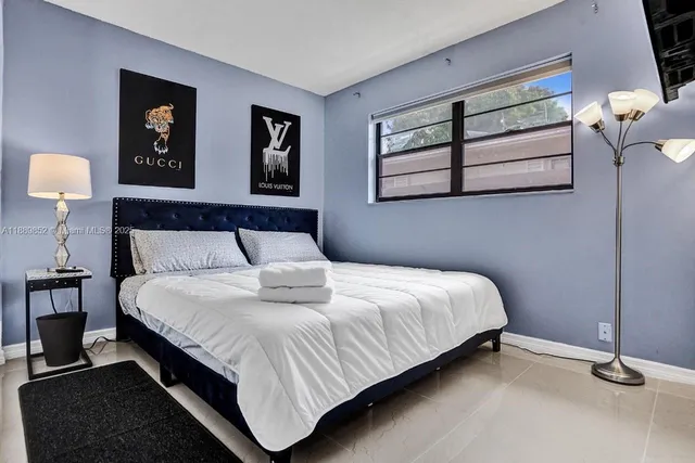 a bedroom with a bed and window