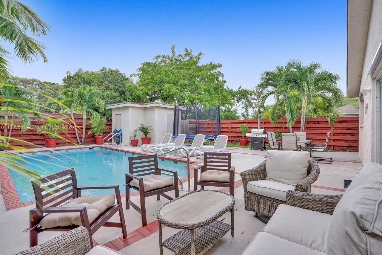 208 Southwest 2nd Avenue Hallandale Beach, FL 33009 - Photo 2 of 28 a view of a chairs and table in patio