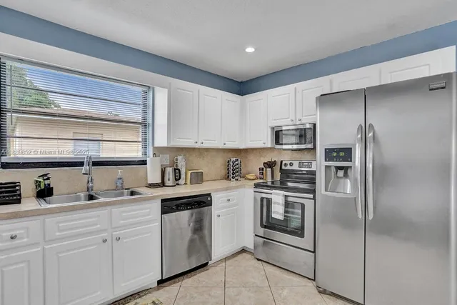 a kitchen with a refrigerator sink and microwave
