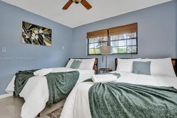 a bed sitting in a bedroom next to a window