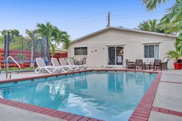 a view of a backyard with swimming pool
